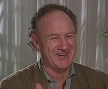 Gene Hackman w roli filmowej, z intensywnym spojrzeniem, ukazujący swoją charyzmę aktorską.